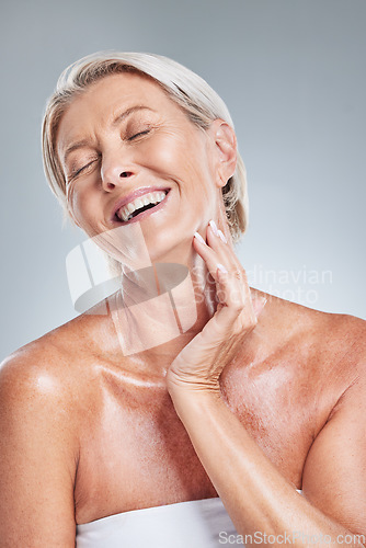 Image of Happy, senior woman and skincare in studio for cleaning, grooming and wellness on a grey background mockup. Skin, relax and elderly model laugh, enjoy and relax with wrinkles, beauty and treatment