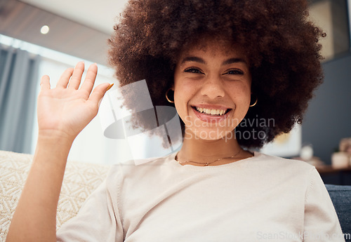 Image of Smile on face, wave and video call, black woman with afro, happy and sitting on sofa in living room. Relax at home, chat online and connect woman on internet networking and communication on videocall