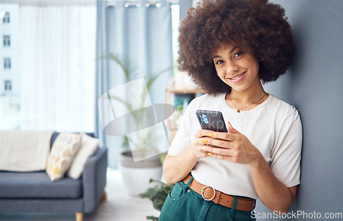 Image of Portrait, woman and phone for social media, afro and happy with online app, web and text contact in home. Beauty, afro and fashion female with 5g mobile smartphone with internet content in the lounge