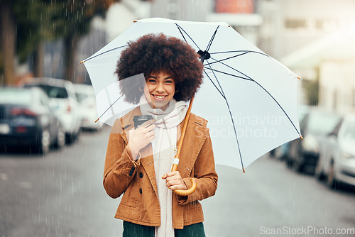 Image of Black woman afro, umbrella and smile for city travel, tourism or love for rain in the street outdoors. Portrait of African American female smiling in happiness for rainy day preparation in the town