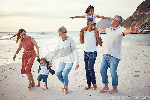 Image of Happy big family, vacation and beach walk for quality bonding time together in the outdoors. Mother, father and grandparents with children playing with smile in happiness for family trip by the ocean