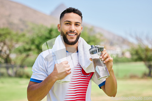 Image of Portrait, fitness and soccer player drinking water in training, cardio exercise and football field workout. Happy, sports and healthy man relaxing and enjoying a resting break with a liquid beverage