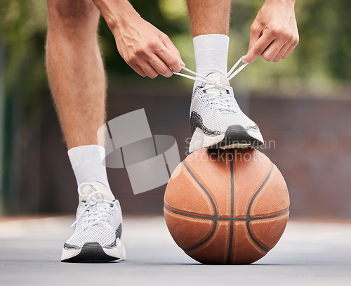 Image of Basketball, athlete with shoelace, shoes and sport on basketball court outdoor, fitness and exercise motivation. Man, basketball player and ready for game, training and active with cardio and sports.