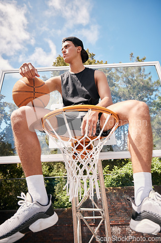 Image of Basketball, sports and man on basket with ball for fitness, exercise and training workout at a community park with sports sneakers. Basketball player, urban court and game with male athlete thinking