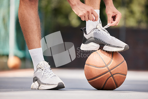Image of Tie shoes, sports and hands on a basketball court getting ready for training, cardio workout and fitness exercise. Footwear, sneakers and healthy athlete in preparation for a practice game or match
