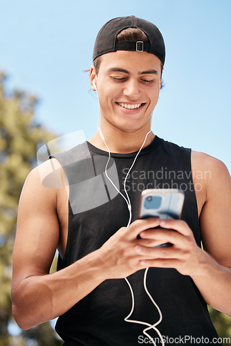 Image of Fitness, phone and man on social media for a meme, internet entertainment or trending online content outdoors. Smile, happy and healthy athlete texting, posting or typing a funny message on cool app