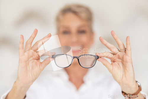 Image of Vision, eyesight and glasses in hands with blur, woman has poor eye sight holding spectacles in blurred background. Healthcare, medical insurance and eyes, prescription lens in clear spectacle frames