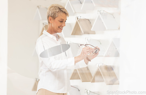 Image of Optometry, shopping and senior woman choosing a new frame at a modern retail eyewear store. Vision, eyesight and elderly lady in retirement picking spectacles for a prescription lens in optical shop.