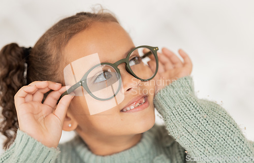 Image of Child, glasses and eye care for vision, focus and concentration while wearing quality lens frame optician choice. Face of girl looking happy about optics fashion mockup for eyesight correction