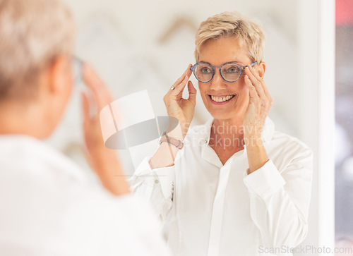 Image of Senior woman, smile and mirror for glasses, vision or eyesight at optometry store. Happy elderly female smiling in happiness for new spectacles looking at reflection in eye care at the optometrist