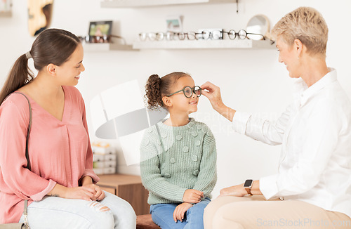 Image of Vision glasses, mother and child with optometrist for eye care consultation, prescription eyeglasses or eyesight test. Optometry lens store, ophthalmology healthcare support and patient at eye exam