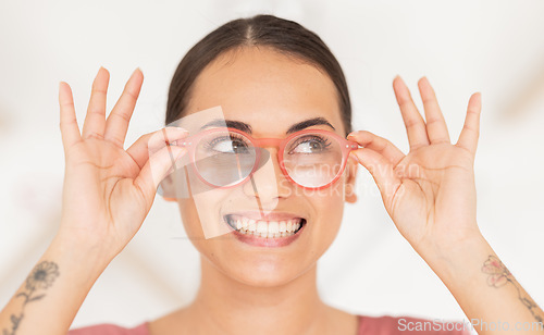 Image of Vision, eyesight and woman putting on glasses with smile holding spectacles on face. Healthcare, medical insurance and eyes, happy girl with trendy prescription lens in spectacle frame at eye exam.