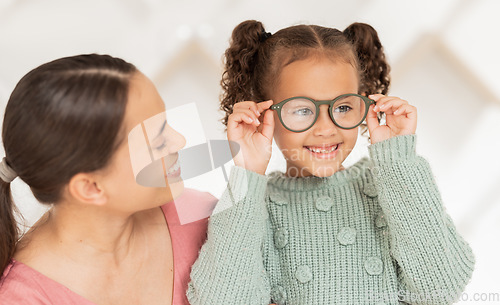 Image of Optometry, vision and mother with child with glasses after examination, test and diagnosis for eyesight. Family, healthcare and happy girl with new spectacles in doctor office after optical exam