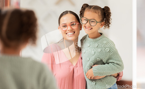 Image of Family, optics store and shopping with mother and child looking at glasses choice in mirror for eye care, vision and optical health. Woman and girl customer with fashion lens or frame in retail shop