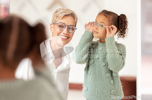 Image of Eyes, consulting and glasses by girl and optometrist woman at optician store for choice, fitting and eye test. Eyesight, eyeglasses and ophthalmologist and child consultation, eye care and vision