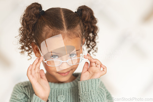 Image of Little girl, glasses and vision portrait with a child wearing eyeglasses in eyewear store for eye care. Optometry, ophthalmology and cute female child posing with spectacles and lenses in retail shop