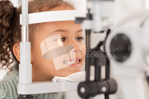Image of Vision, test and girl for eye exam in the opthalmologist office with equipment for glasses. Optics, examination and female child testing for eyecare health or wellness for optometry for healthcare