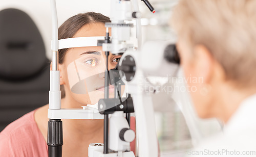Image of Woman at eye lens test, healthcare for vision by optician for contact lens and focus with laser medical tool. Eyesight, expert optometrist consulting glaucoma patients insurance and visual zoom