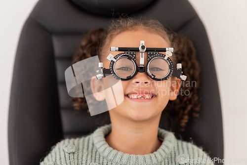 Image of Trial frame, vision and eye test of girl at hospital or optometry clinic for eyewear, health and eye wellness. Exam, glasses and child testing eyesight for new optical lenses, frames or spectacles.