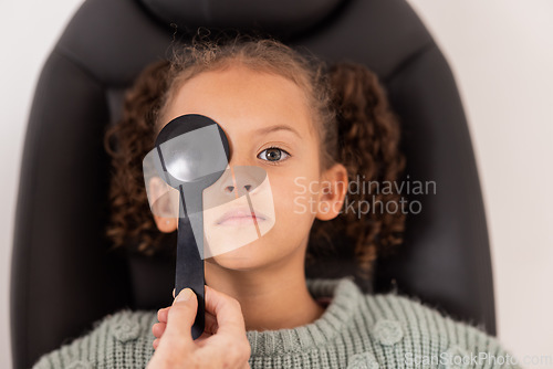 Image of Optometry, eye care and girl getting a vision test with a occluder in a medical optical clinic. Checkup, optometrist and child from Brazil doing a eye exam with a optic tool for healthy eyesight.