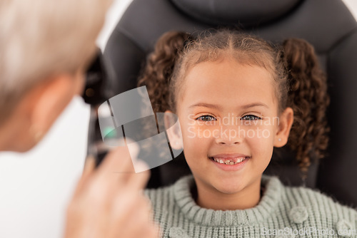 Image of Happy portrait of girl, test eye vision by optician checking childs eyes in consultation room and smile at doctor. Healthcare professional consulting kid, young patient with optometrist or eye exam