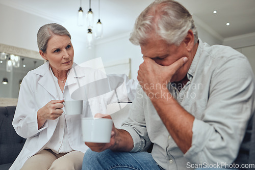 Image of Coffee, depression and support with a senior man talking to a doctor while on a sofa together. Cancer, sad and mental health with a mature patient and woman showing compassion in a retirement home