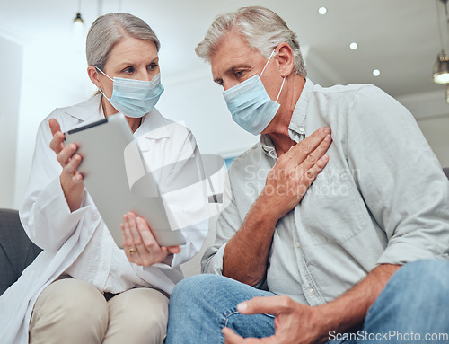 Image of Covid, tablet and healthcare with a senior man patient and doctor during a home visit for a checkup appointment. Medical, consulting and mask with a woman health professional talking to a mature male