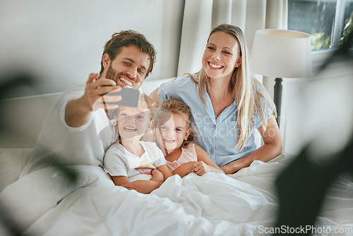 Image of Morning, bed and happy family take a selfie with a smile enjoying quality time, bonding and relaxing at home. Pictures, mother and father with young children, kids or siblings in the house bedroom