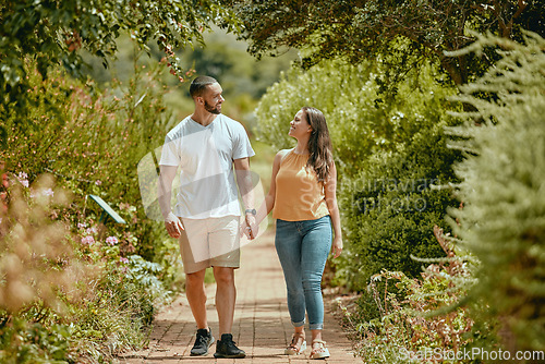 Image of Couple, hand holding and nature park walking of people on a outdoor path with a smile. Happy girlfriend and boyfriend together showing love, care and commitment on a walk or hike feeling happiness