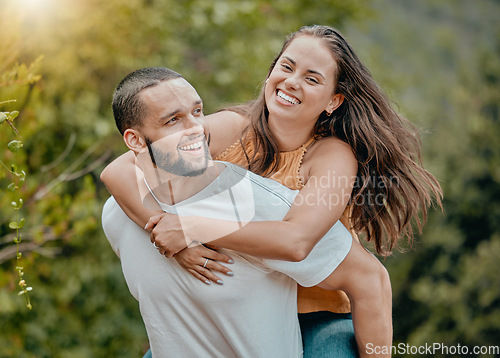 Image of Love, fun and nature couple hug while playing, happy and enjoy outdoor quality time together in Toronto Canada park. Freedom peace, partnership trust and man piggyback woman on romantic bonding date