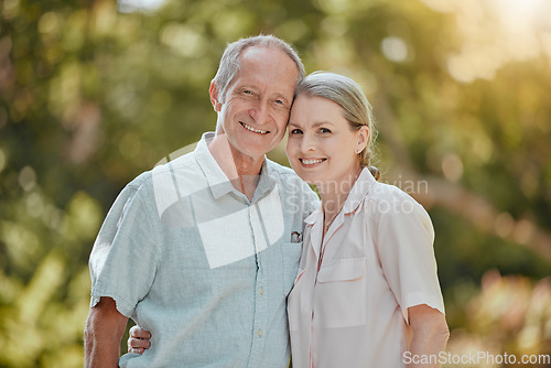 Image of Happy, love and portrait of a senior couple standing in a green garden while on a picnic on vacation. Happiness, smile and elderly man and woman in retirement embracing in a park on holiday in Canada