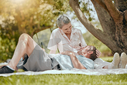 Image of Love, happy and elderly couple relax on picnic, bond and rest in a park, having fun on a date. Lovers, retirement and senior man and woman sharing romance, happy and smile against forest tree