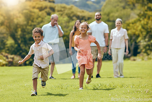 Image of Running, happy and summer with big family in park for happy, freedom and health. Nature, spring and environment with kids playing and on grass field with parents and grandparents for youth lifestyle