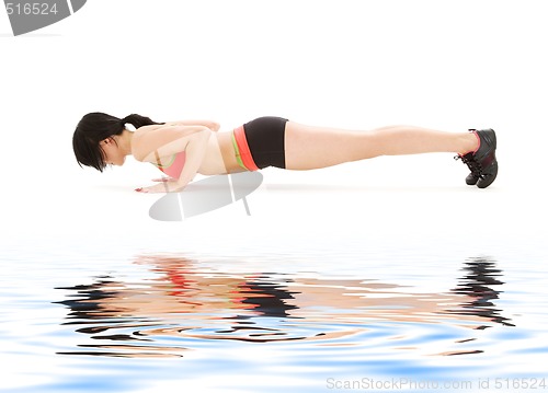 Image of woman practicing four-limbed staff pose