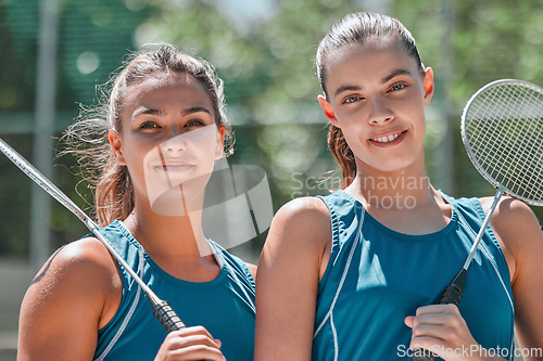 Image of Badminton, women and sports team on an outdoor court ready for exercise, training and game. Portrait of fitness, workout and happy woman athlete people together with a sport racket and smile