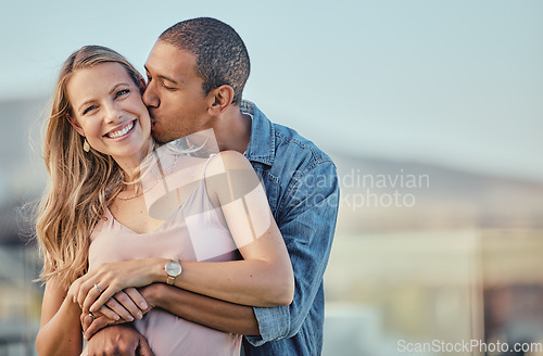 Image of Couple, kiss and smile of people with a hug together outdoor feeling love, care and happiness. Portrait of marriage, commitment and happy interracial relationship hugging and kissing for anniversary