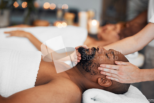 Image of Spa, couple and massage for health and wellness at luxury resort for peace, calm and quiet time with hands of therapist in a beauty salon. Black man lying on bed for body, mind and head care at hotel