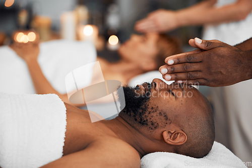 Image of Black man, head massage and being calm, relax and clear mind being stress free, release tension and calm laying on table. African American male, spa treatment and body care for wellness or health