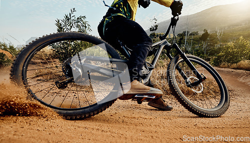 Image of Sports, action and biker dirt racing on mountain bike enjoying riding, cycling and moving with speed. Extreme sports, mountain biking and athlete drifting on dirt road for fitness, adrenaline and fun