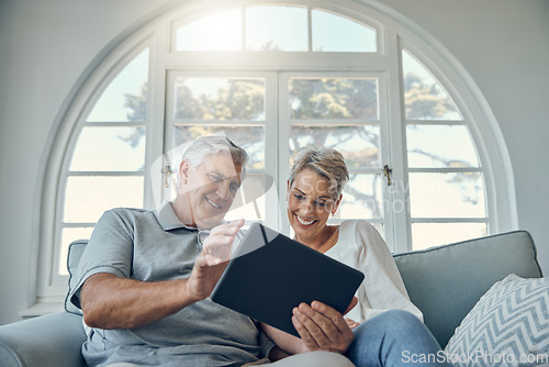 Image of Senior couple tablet, relax smile and living room sofa for social media, email or internet video. Woman man retirement, home happiness with mobile technology and comic social network on web app