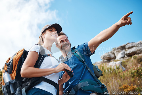 Image of Couple, pointing and bonding on hiking mountains, nature earth environment or countryside hills in Canada. Smile, happy and hiker man and woman backpacking or sightseeing camping land with binoculars