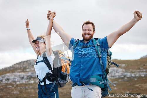 Image of Hiking, victory and mountain with a winner couple in celebration of success while walking outdoor in nature together. Wow, travel and freedom with a man and woman hiker celebrating at the summit peak