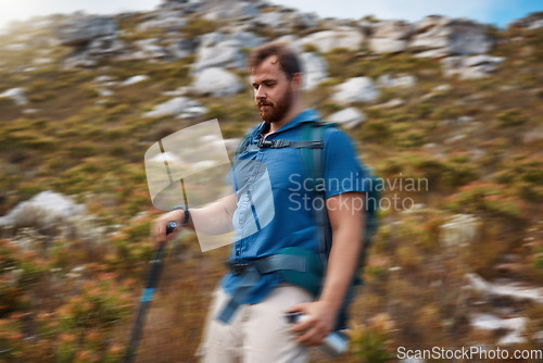 Image of Blur motion, hiking and man on outdoor for health, wellness and on mountain range with stick for balance. Nature, healthy male and hiker enjoy walking, exercise and natural space for adventure.