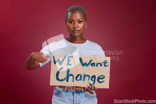 Image of Black woman, cardboard sign and protest for change, end racism and equality for people on studio background. Young girl, point to poster and human rights to fight against discrimination and gesture.