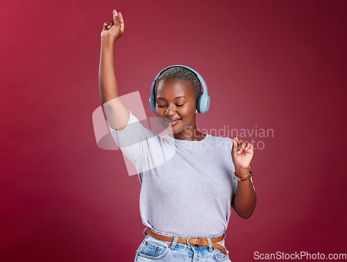 Image of Studio, dance and black woman streaming music and dancing with freedom and happiness to relax. Smile, headphones and happy African girl enjoys listening to a gospel worship song or audio on radio