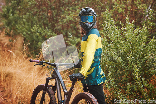 Image of Mountain bike man with cycling helmet taking a break from adventure, action sports and freedom on off road, nature and dirt path. Bicycle athlete stop outdoors after training, workout and biker race
