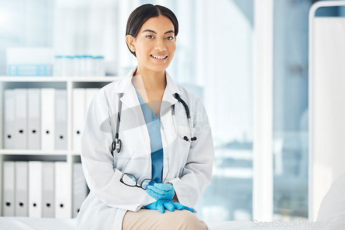 Image of Healthcare, medicine and a happy doctor, woman in her office with a smile and a stethoscope. Vision, success and empowerment, portrait of a female medical professional or health care employee at work