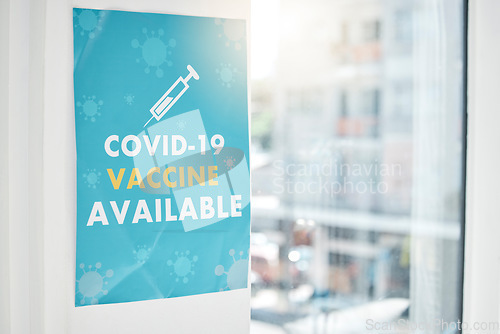 Image of Poster, covid and vaccine with a sign on a wall in an empty hospital or clinic for healthcare and medication. Advert, corona virus and vaccination with a message in a health center for treatment