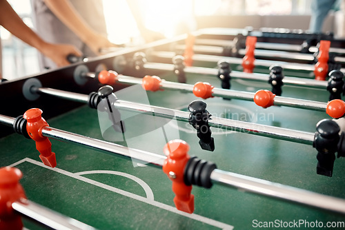 Image of People hands, foosball table and competition in arcade with retro games, soccer action board and plastic toys for team play. Closeup of tabletop soccer challenge, football fun and party entertainment
