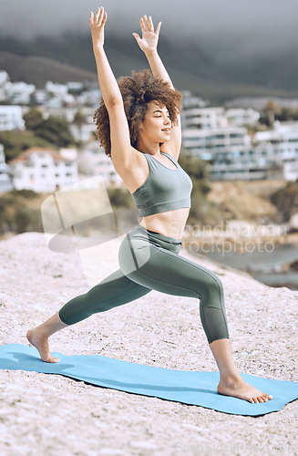 Image of Woman, stretching or yoga mat on beach rock in relax workout, exercise or fitness for body wellness or mental health peace. Smile, happy or zen afro yogi in pilates training by Brazilian nature ocean